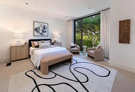 a view of a room with a mirror and a wooden door