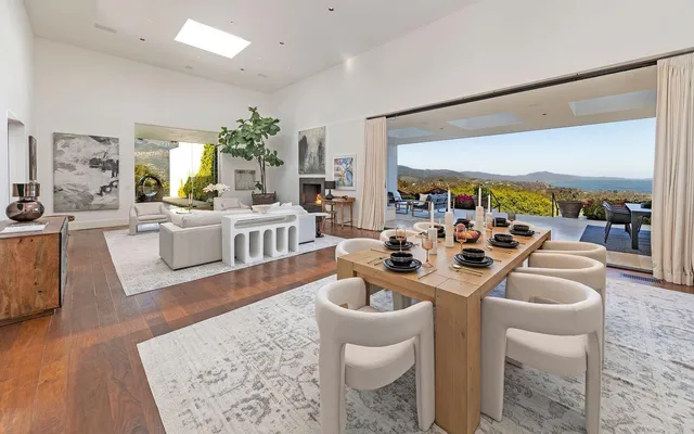 a kitchen that has a lot of cabinets in it and wooden floors