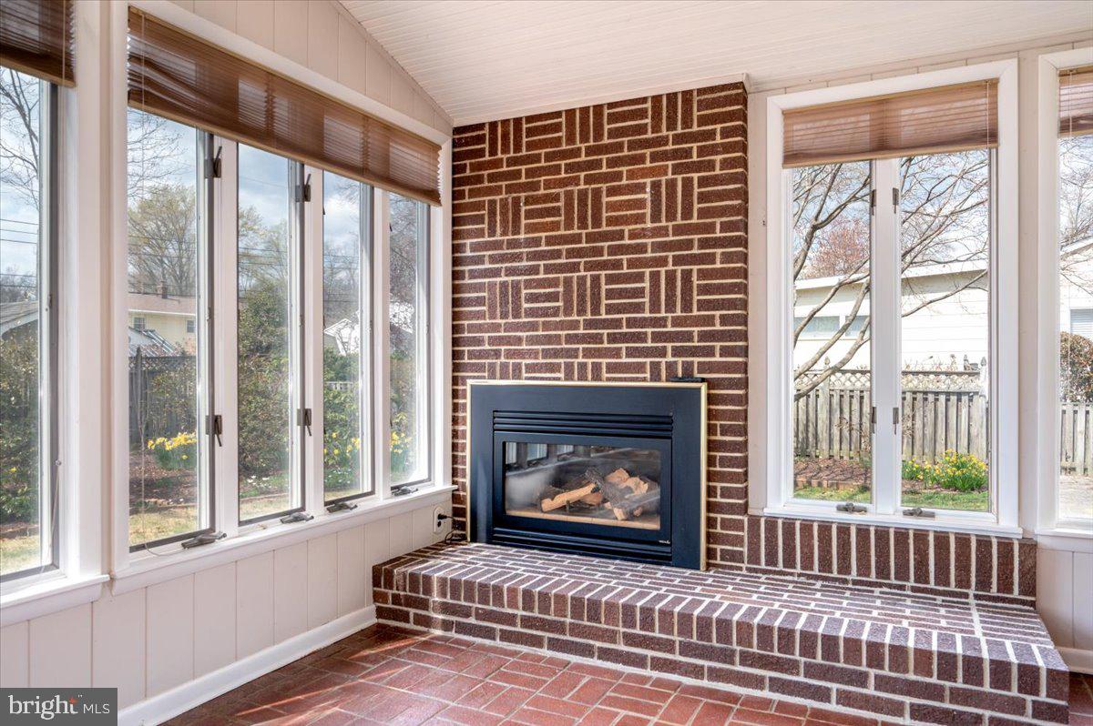 162 Sillery Bay Road Pasadena, MD 21122 - Photo 21 of 41 a living room with a fireplace and a floor to ceiling window