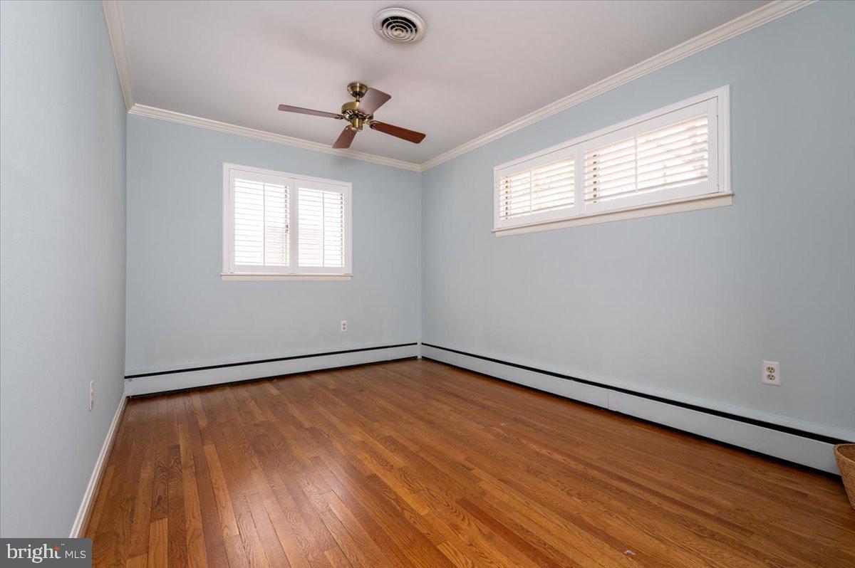 162 Sillery Bay Road Pasadena, MD 21122 - Photo 24 of 41 a view of an empty room with wooden floor and a window