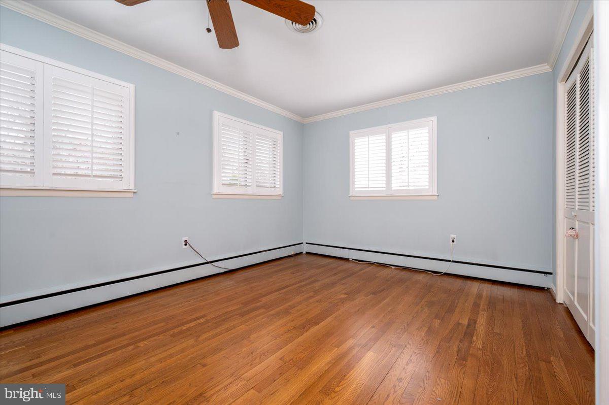 162 Sillery Bay Road Pasadena, MD 21122 - Photo 25 of 41 an empty room with wooden floor and windows