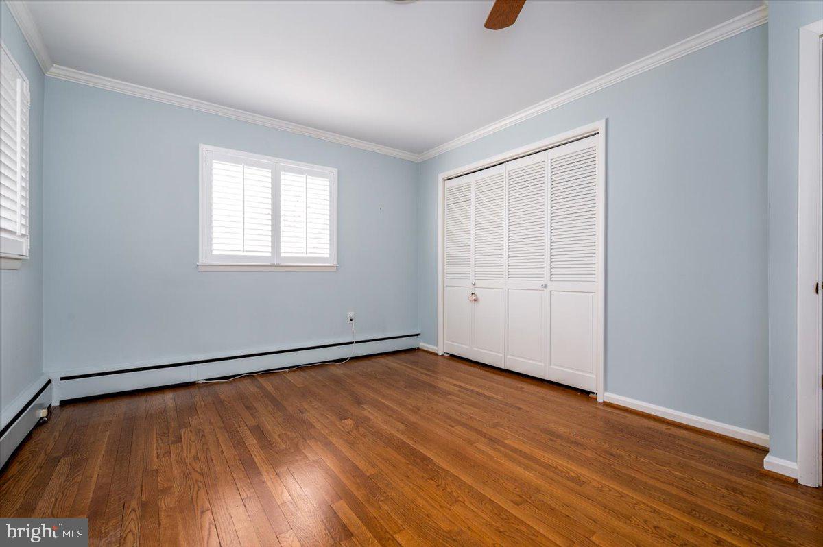 162 Sillery Bay Road Pasadena, MD 21122 - Photo 26 of 41 an empty room with wooden floor and windows