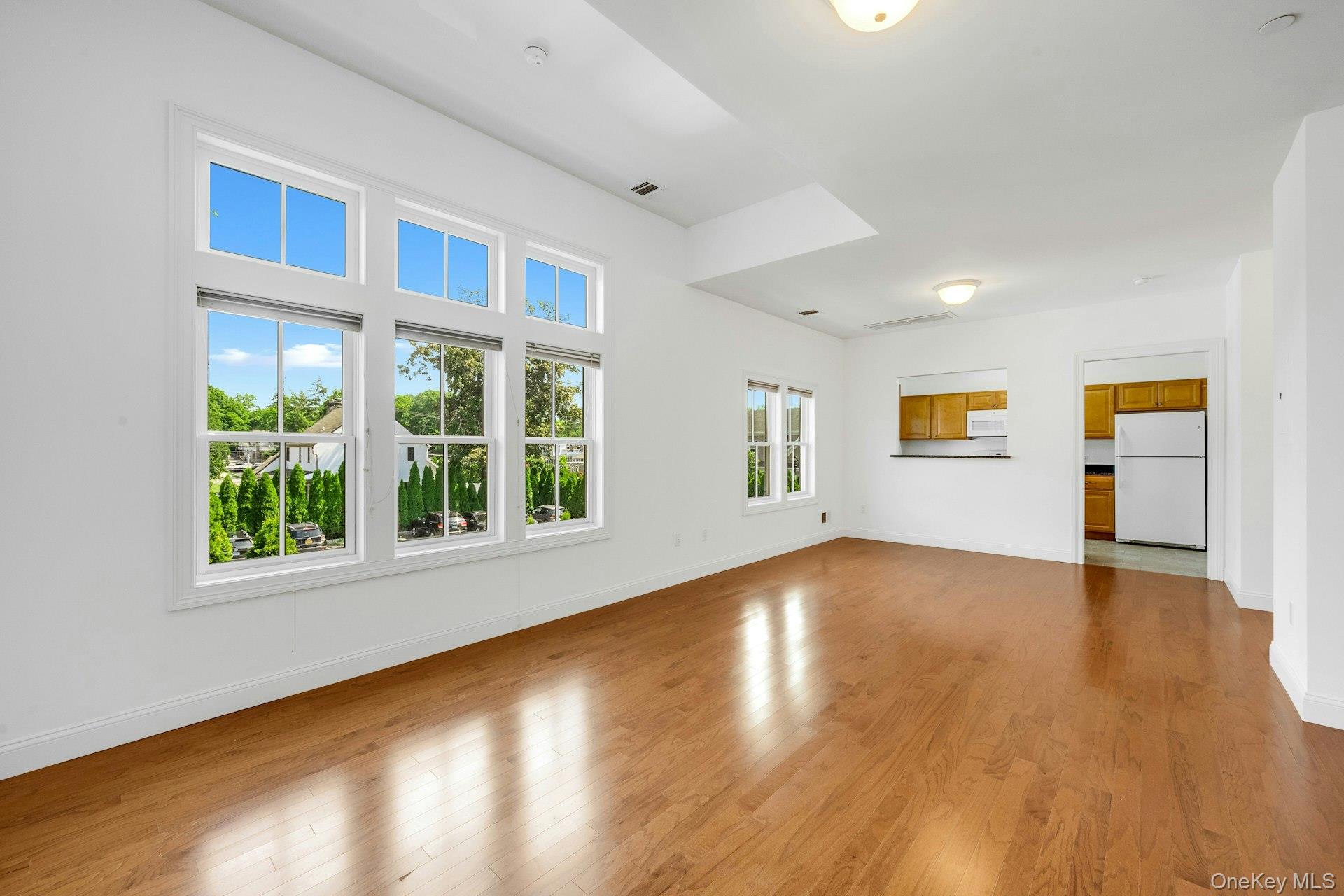 402 Main Street, Unit 3 Armonk, NY 10504 - Photo 1 of 1 a view of an empty room with wooden floor and a window