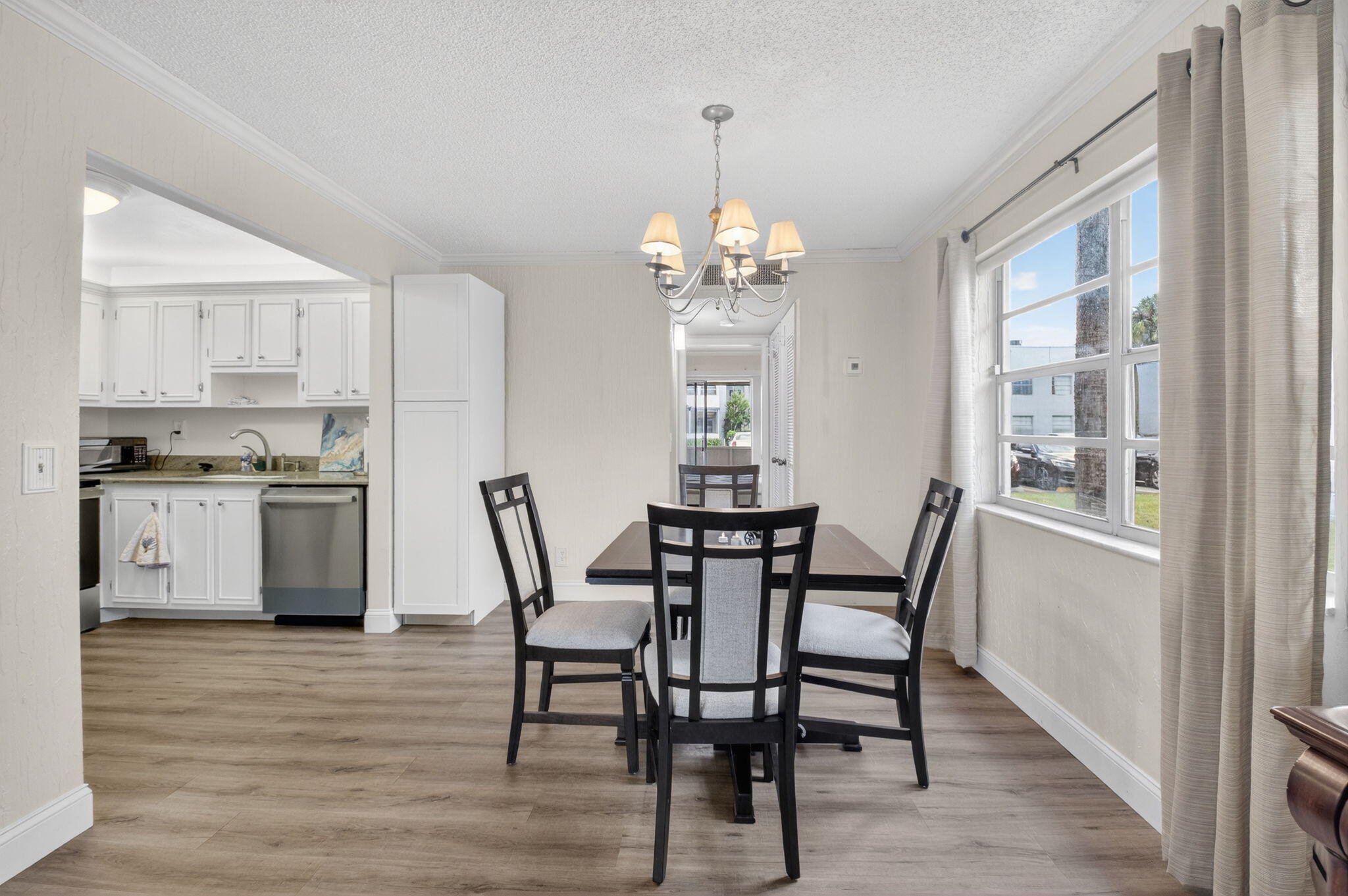 111 Normandy Lane Delray Beach, FL 33484 - Photo 3 of 14 a dining room with furniture a chandelier and wooden floor