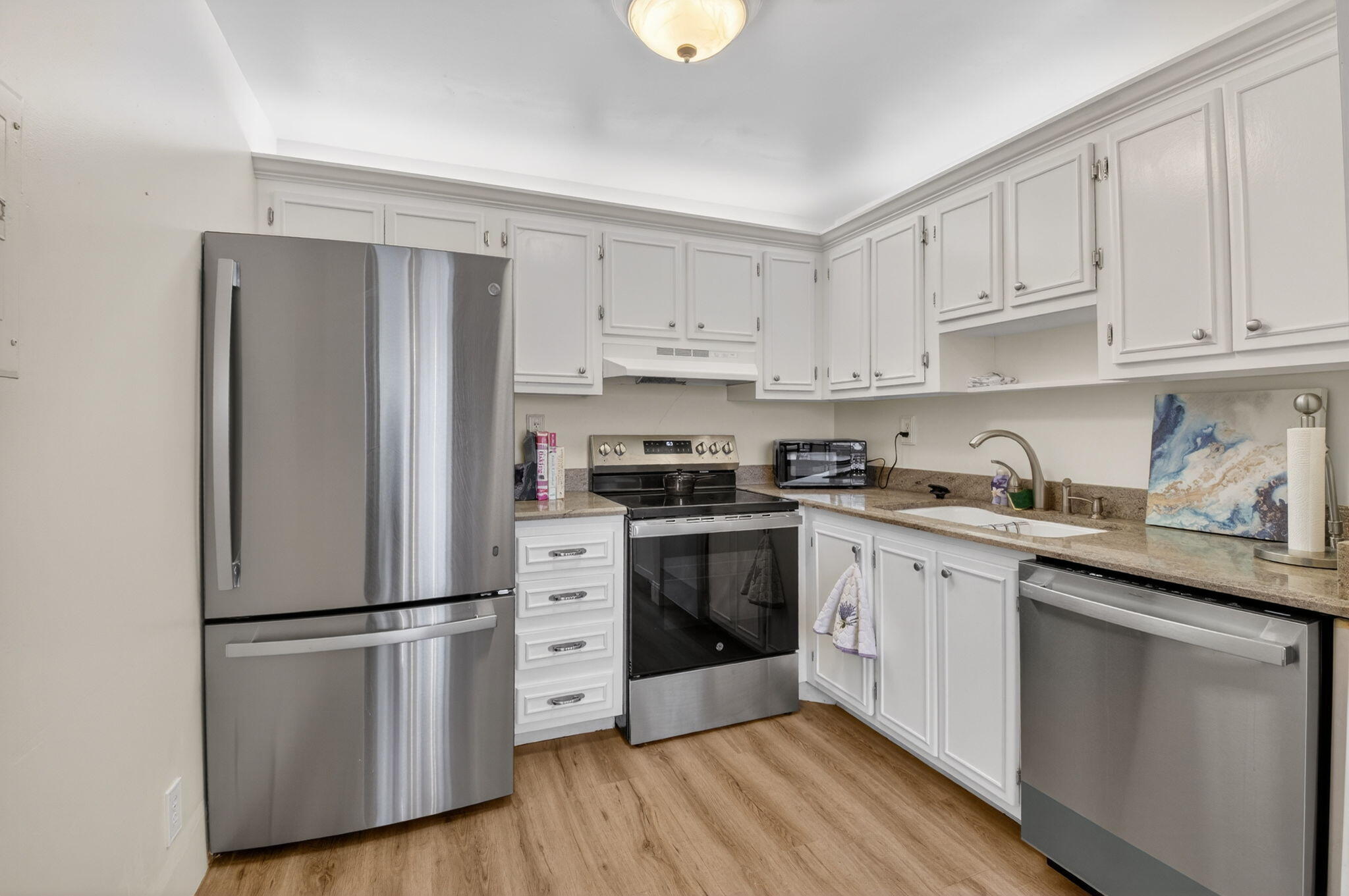 111 Normandy Lane Delray Beach, FL 33484 - Photo 4 of 14 a kitchen with stainless steel appliances granite countertop a refrigerator sink and cabinets