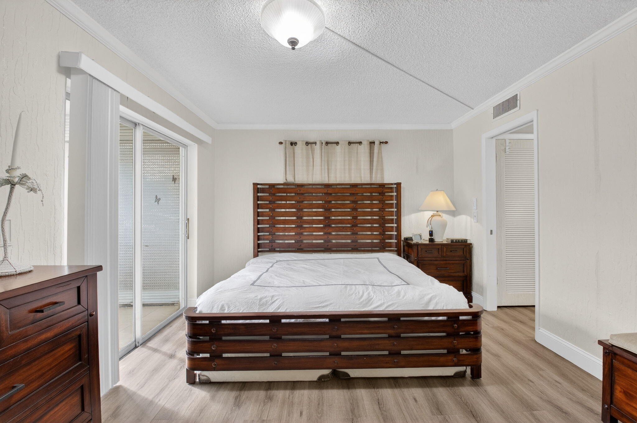 111 Normandy Lane Delray Beach, FL 33484 - Photo 5 of 14 a bed sitting in a room next to a window