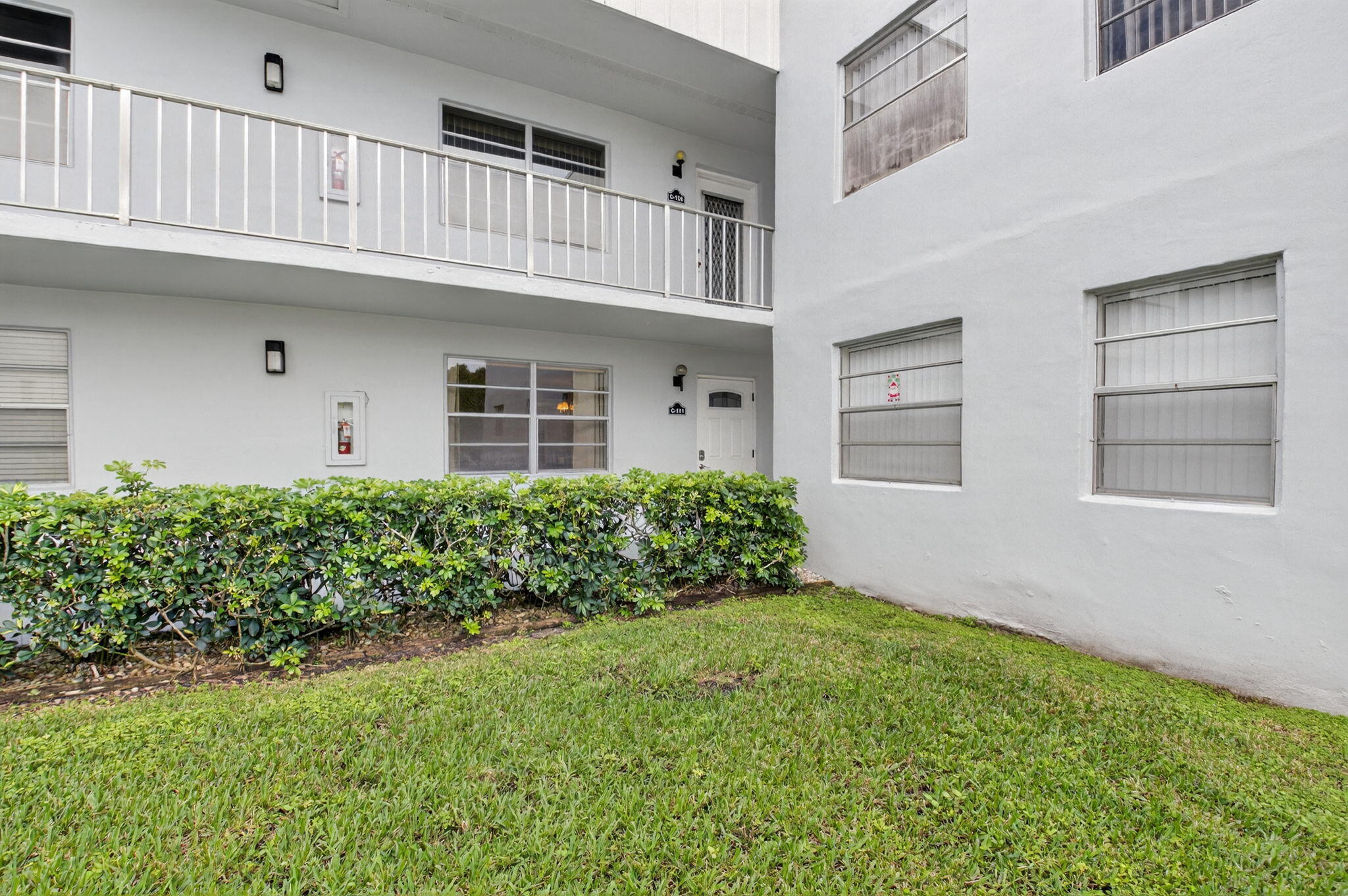 111 Normandy Lane Delray Beach, FL 33484 - Photo 9 of 14 front view of a house with a yard