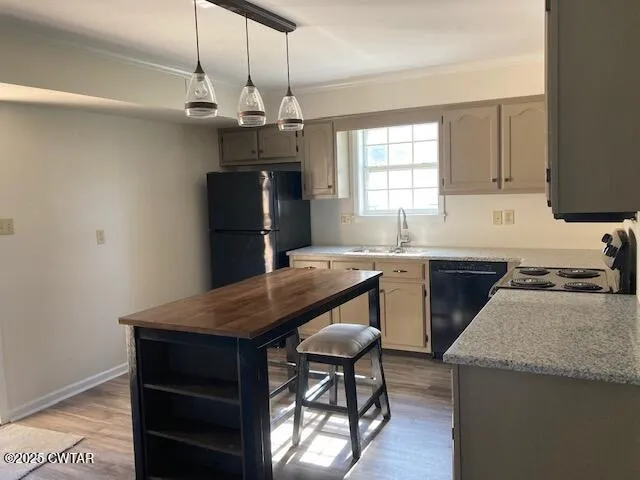 a kitchen with granite countertop wooden cabinets a stove a sink and a refrigerator