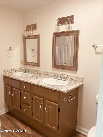 a bathroom with a granite countertop sink a large mirror and a toilet