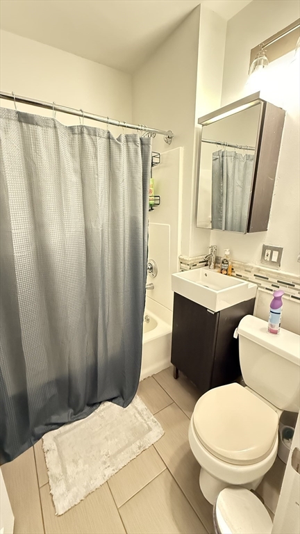 174 Boston Street, Unit 2 Boston, MA 02125 - Photo 6 of 8 a bathroom with a sink a toilet a mirror and shower curtain