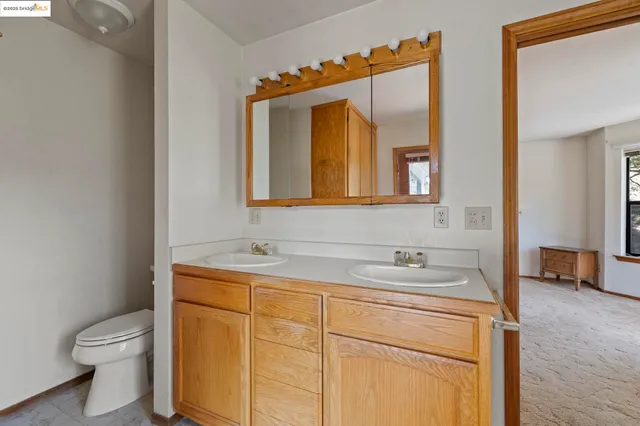 a bathroom with a toilet sink and mirror