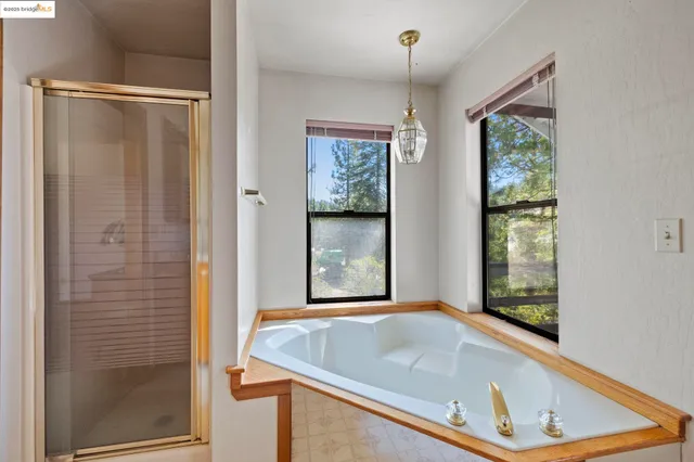 a bathroom with a tub and shower