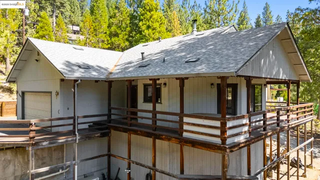 a backyard of a house with barbeque oven table and chairs
