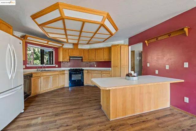 a kitchen with a stove a sink and a refrigerator