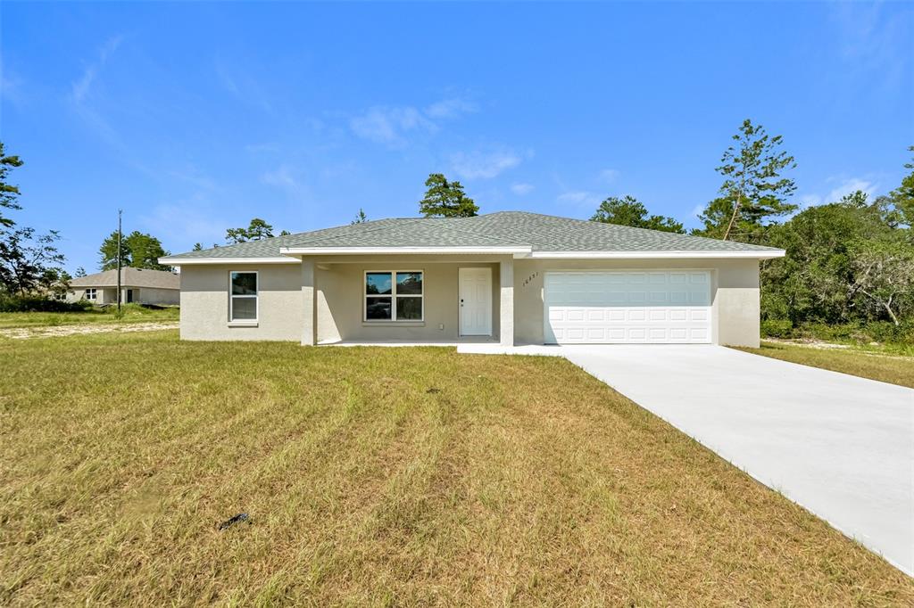 16351 Southwest 27th Terrace Road Ocala, FL 34473 - Photo 1 of 1 a front view of a house with a garden and yard