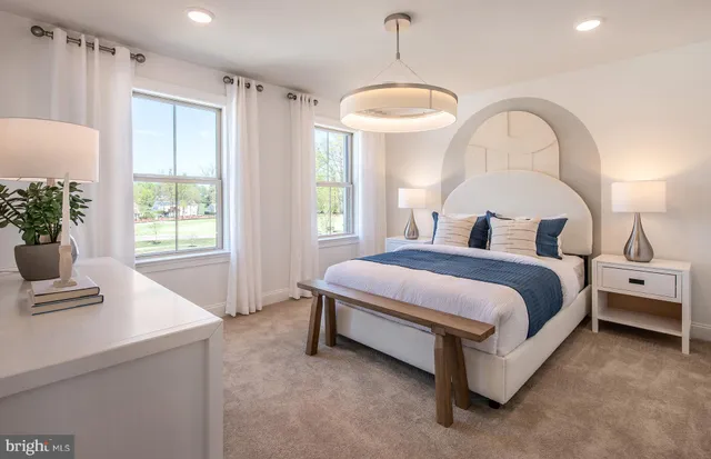 a spacious bedroom with a bed and a window