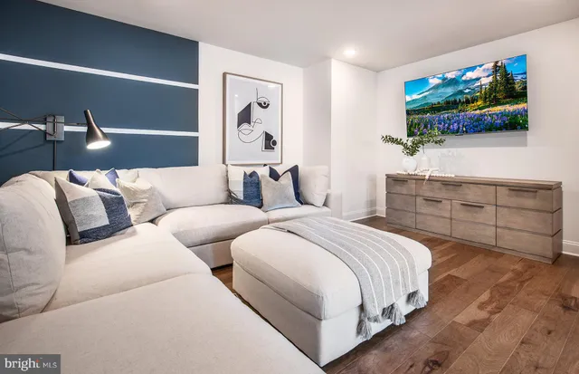 a spacious bedroom with two beds and a flat screen tv