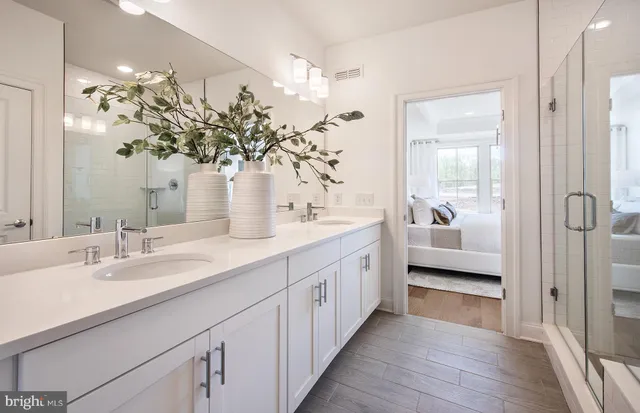 a bathroom with a double vanity sink and mirror