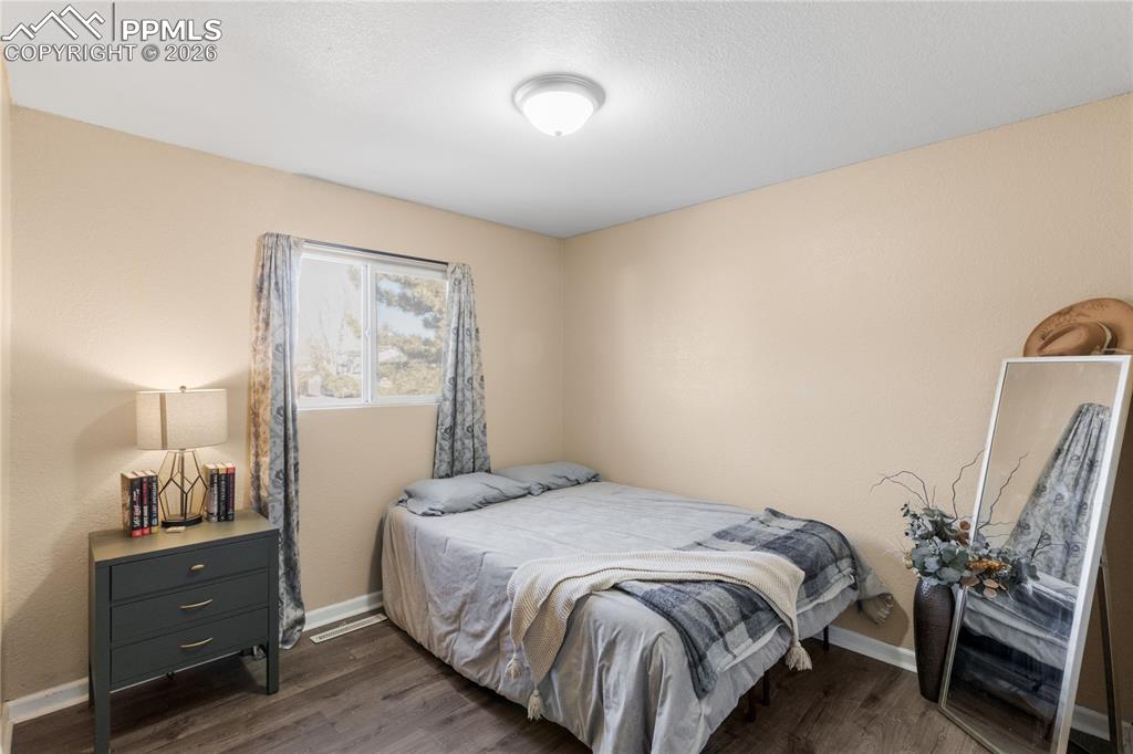 1703 Harrow Road Colorado Springs, CO 80906 - Photo 24 of 32 Bedroom featuring dark wood finished floors