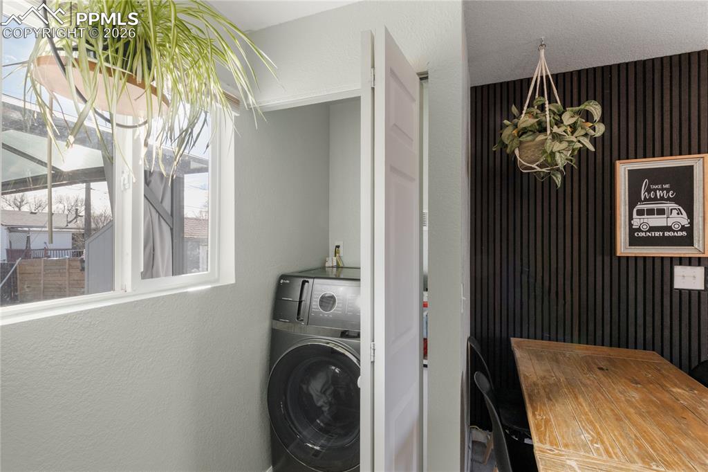 1703 Harrow Road Colorado Springs, CO 80906 - Photo 27 of 32 Laundry area with a textured wall and washer / dryer