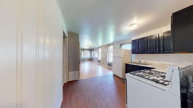 a kitchen with a refrigerator and a stove top oven