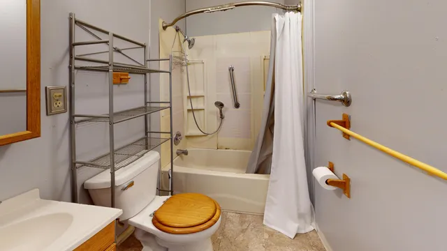 a bathroom with a toilet and a shower