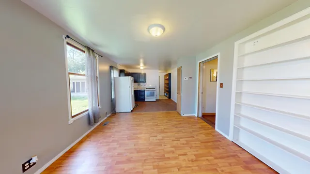 a view of hallway with wooden floor and windows