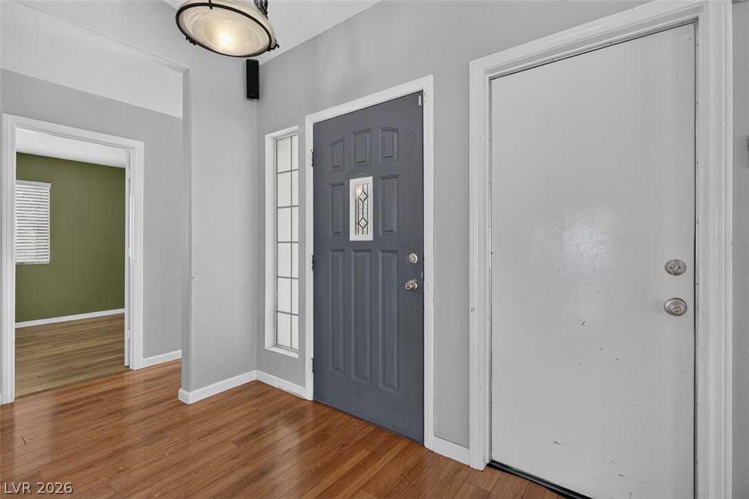 2609 Shakespeare Road Las Vegas, NV 89108 - Photo 4 of 41 A welcoming entryway with richly hued hardwood floors and a statement front door.