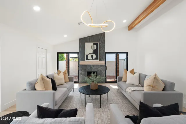 a living room with furniture and a view of kitchen