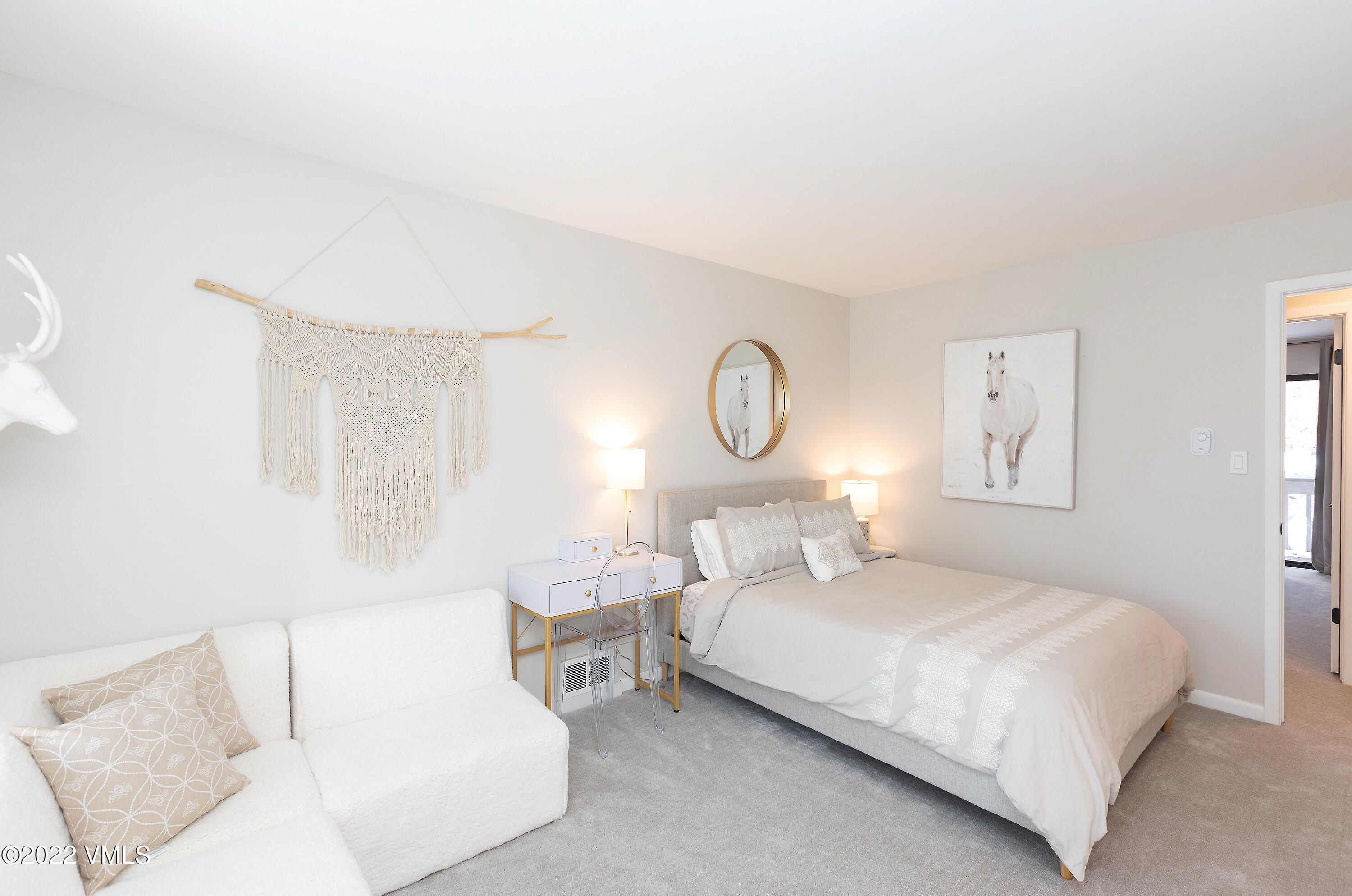 980 Vail View Drive, Unit 111B Vail, CO 81657 - Photo 12 of 17 a bedroom with a bed and a lamp