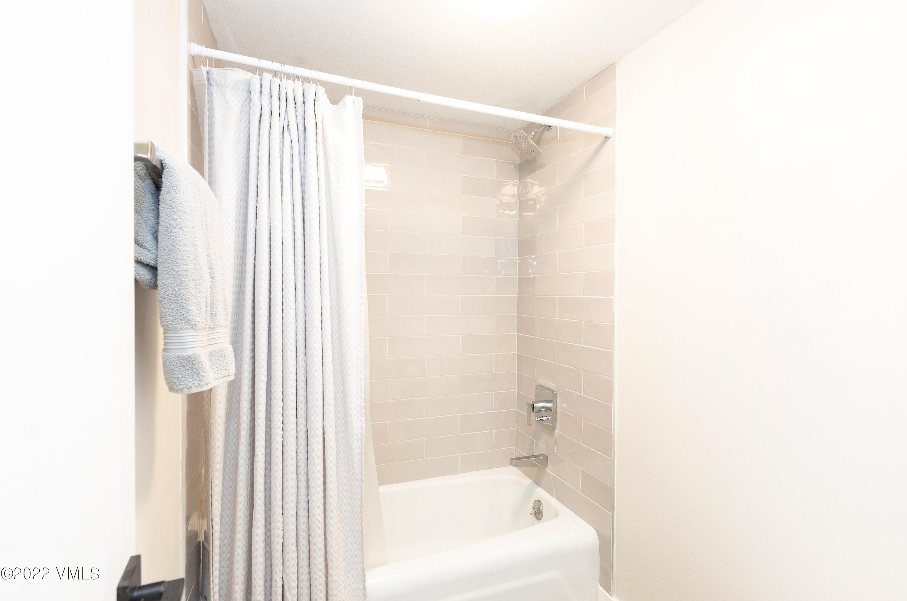 980 Vail View Drive, Unit 111B Vail, CO 81657 - Photo 14 of 17 a bathroom with a bathtub and a shower