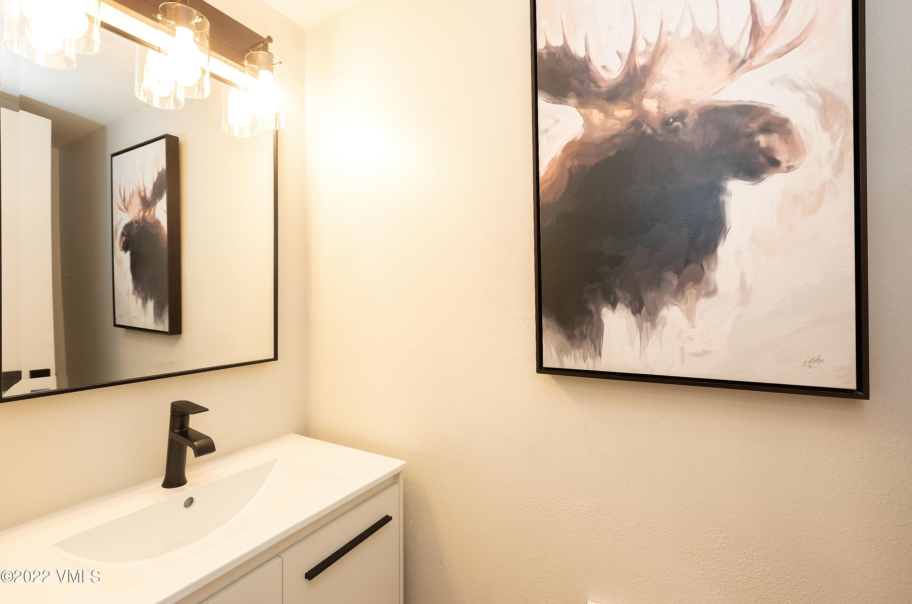 980 Vail View Drive, Unit 111B Vail, CO 81657 - Photo 15 of 17 a bathroom with a sink and mirror