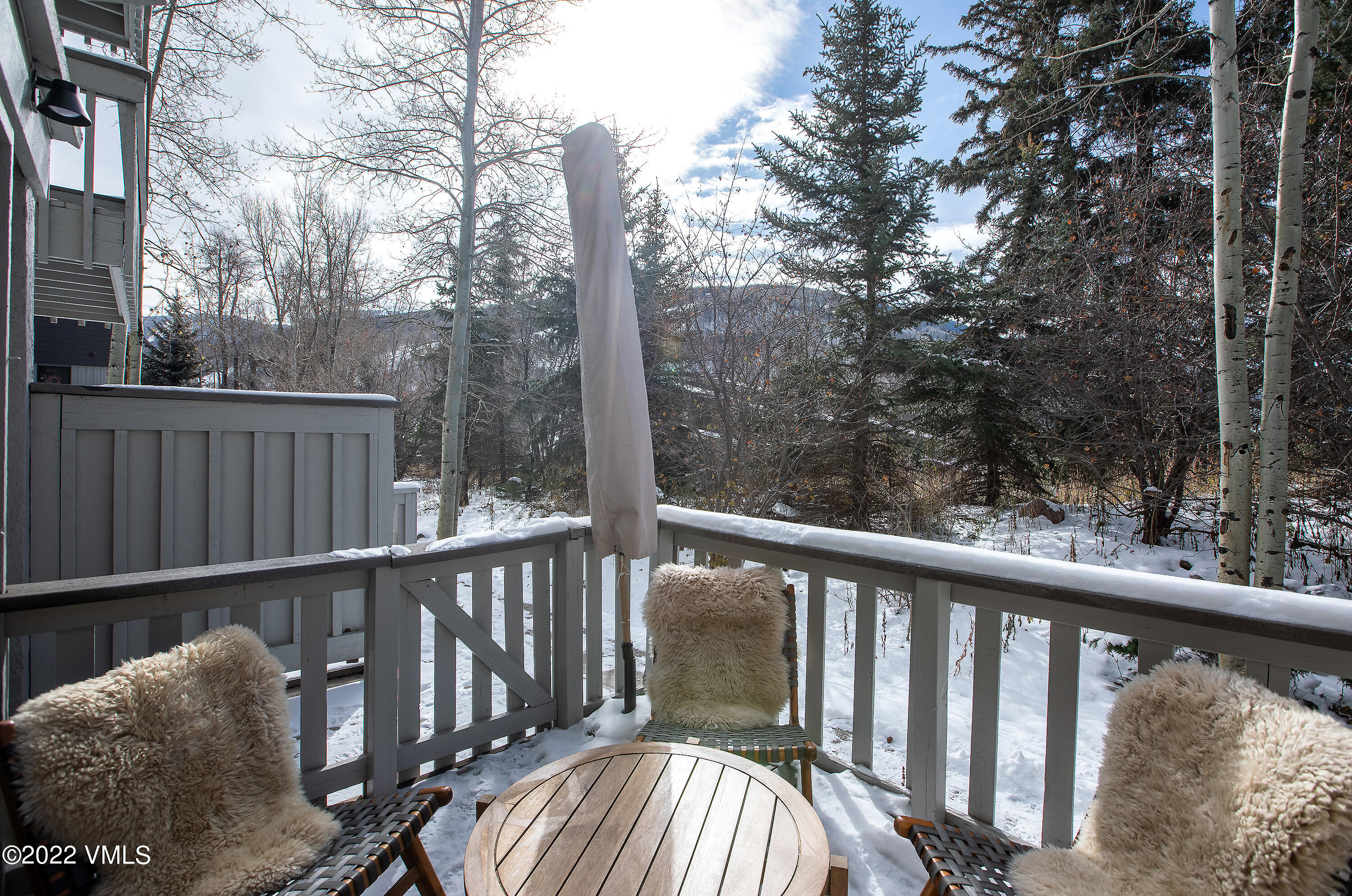 980 Vail View Drive, Unit 111B Vail, CO 81657 - Photo 16 of 17 a view of a balcony with wooden floor and fence