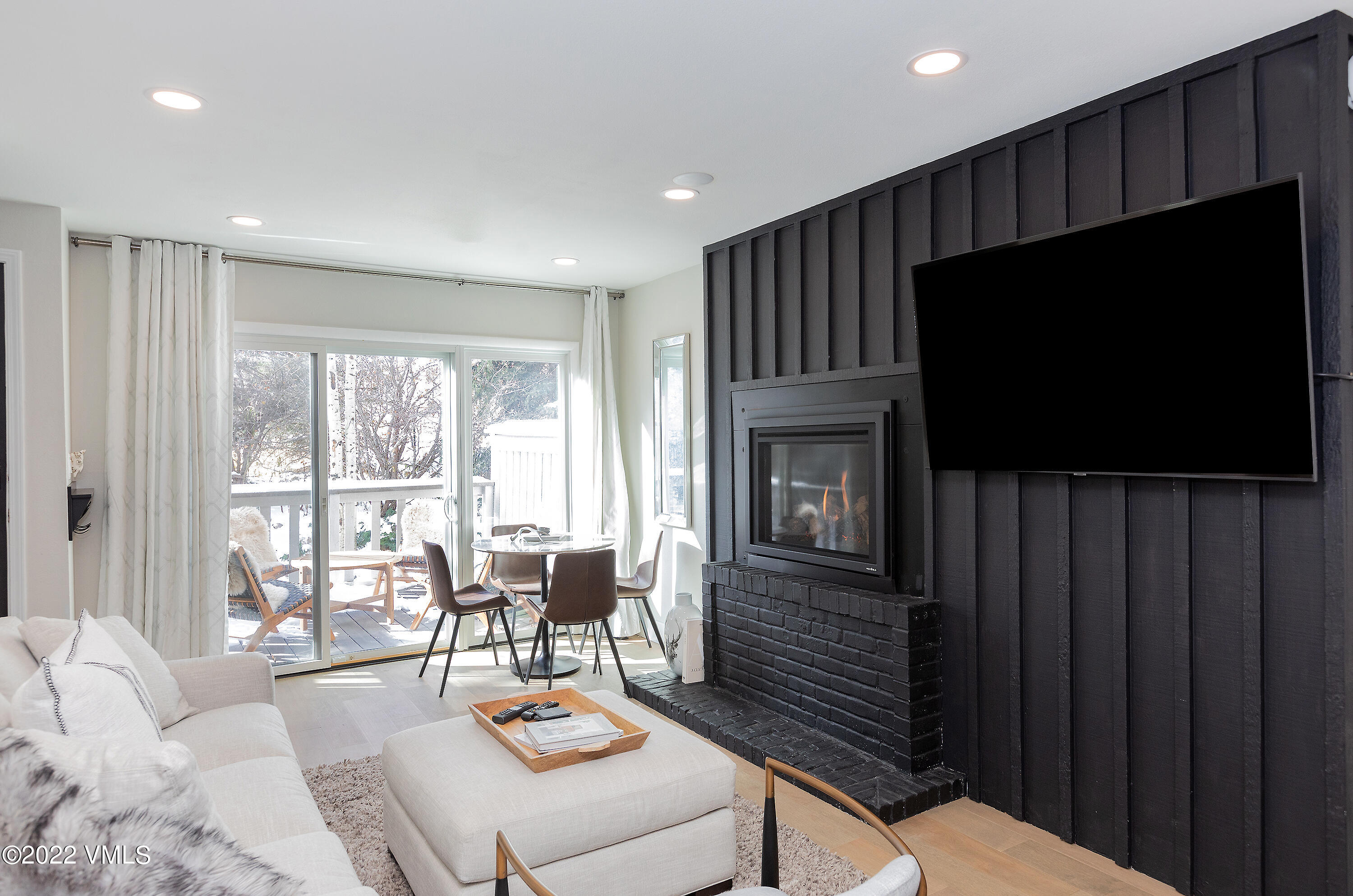 980 Vail View Drive, Unit 111B Vail, CO 81657 - Photo 5 of 17 a living room with fireplace furniture and a flat screen tv