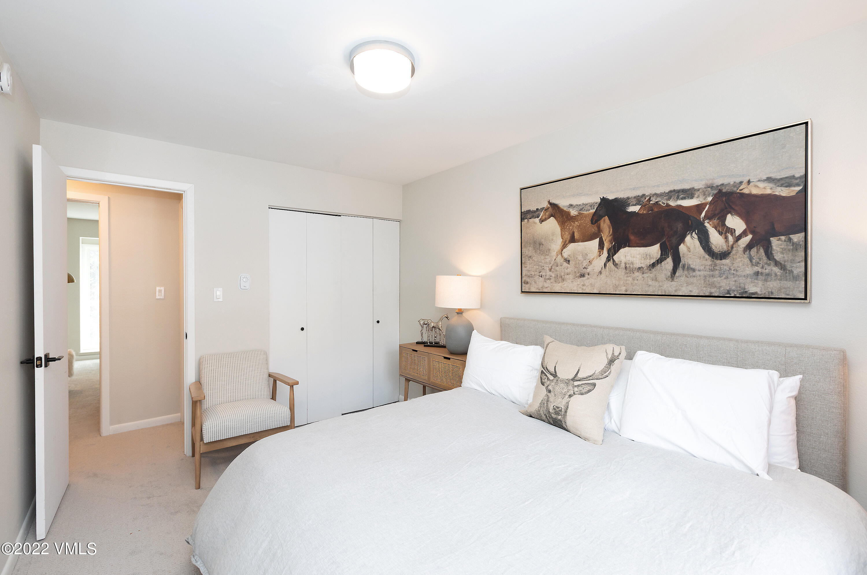 980 Vail View Drive, Unit 111B Vail, CO 81657 - Photo 9 of 17 a bedroom with a bed and painting on the wall