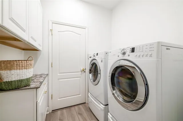 a bedroom with a bed a flat screen tv and a window