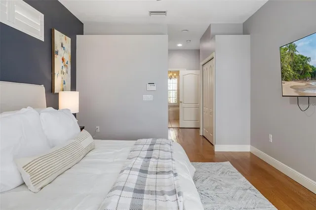a spacious bathroom with a granite countertop sink a mirror a shower and a bathtub