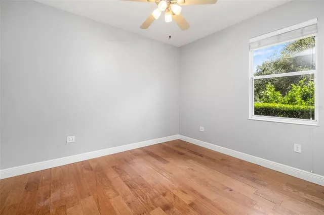 a bathroom with a granite countertop sink a toilet a mirror and shower