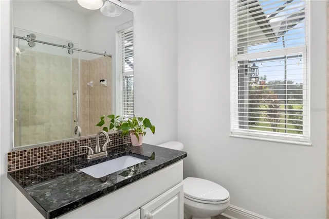 a view of a patio with a table and chairs under an umbrella
