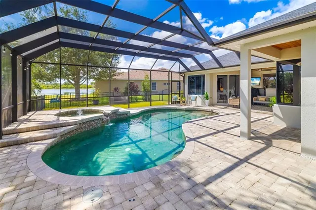 an aerial view of a house with a garden and swimming pool