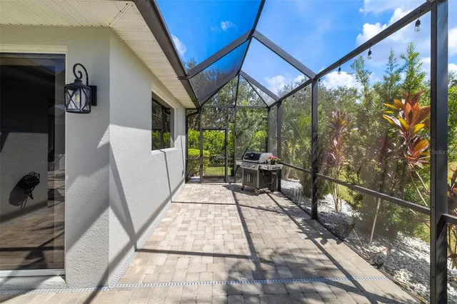 a view of a white house with a large tree