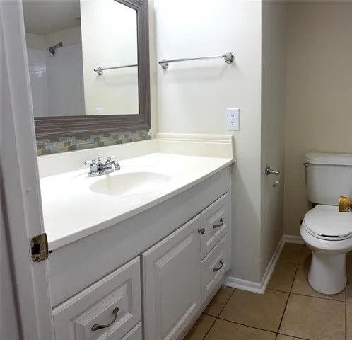a bathroom with a sink a toilet and mirror