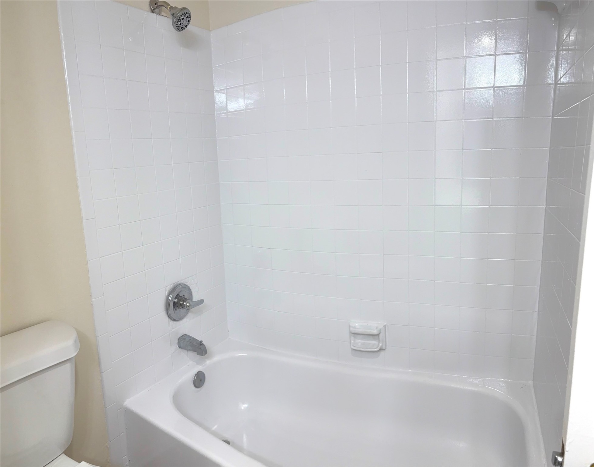 17331 Red Oak Drive, Unit 38 Houston, TX 77090 - Photo 14 of 19 a white bath tub sitting next to a white toilet and a sink