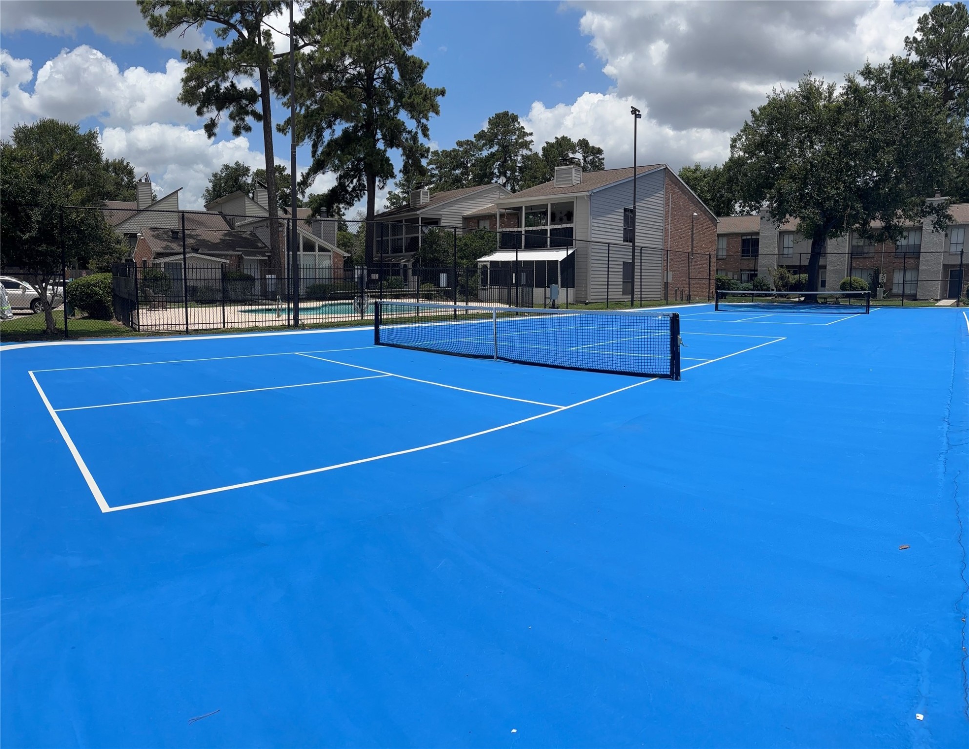 17331 Red Oak Drive, Unit 38 Houston, TX 77090 - Photo 19 of 19 a view of outdoor space and basketball court