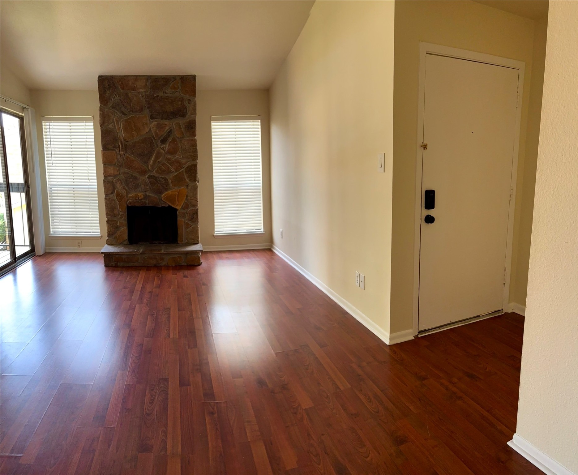 17331 Red Oak Drive, Unit 38 Houston, TX 77090 - Photo 2 of 19 an empty room with wooden floor a fireplace and windows