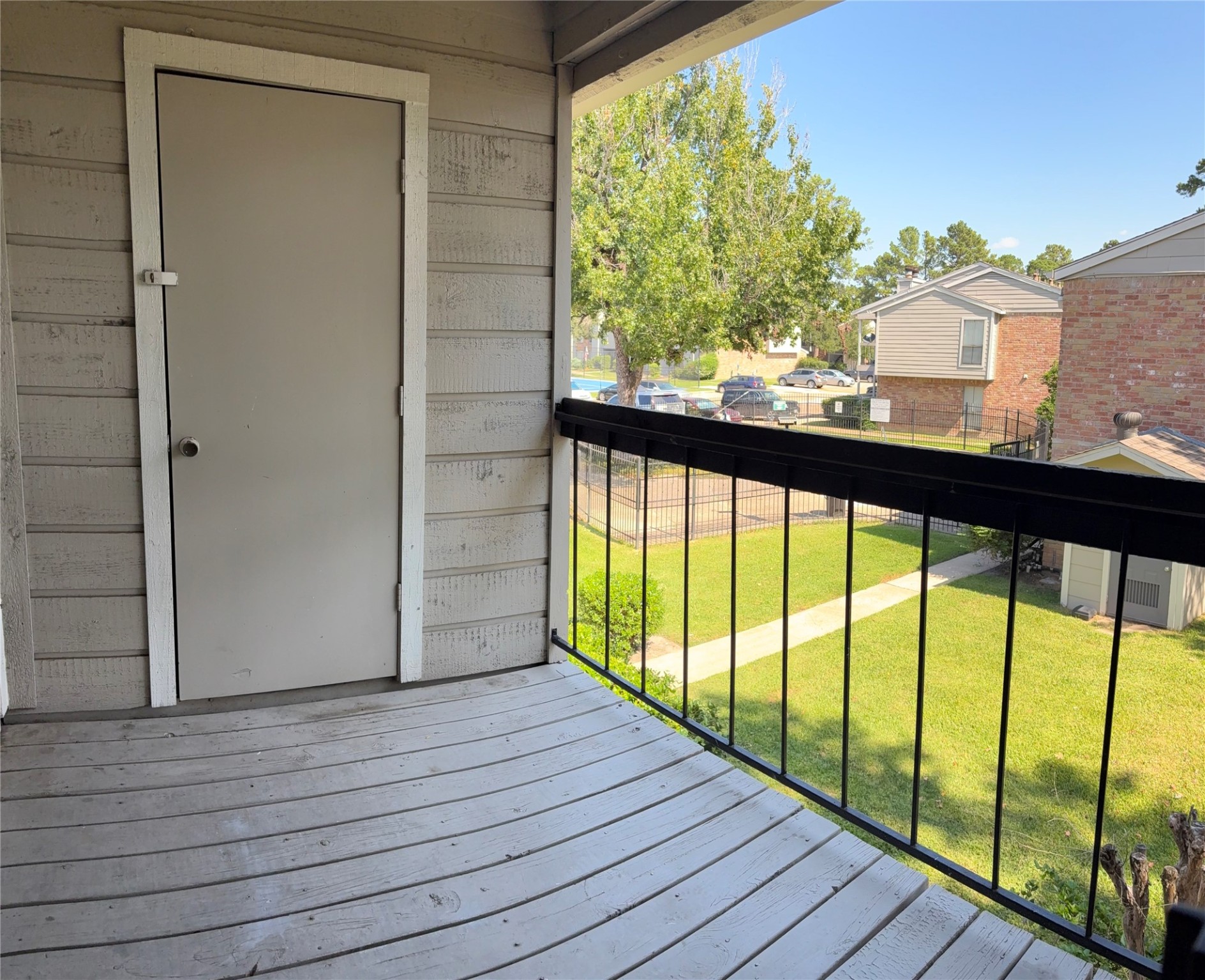 17331 Red Oak Drive, Unit 38 Houston, TX 77090 - Photo 4 of 19 a view of balcony with wooden floor