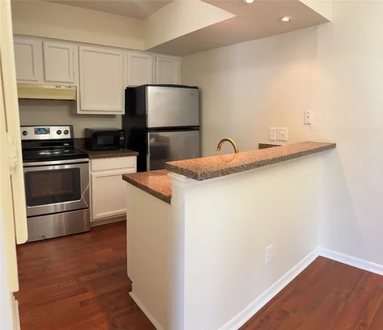 a kitchen with a sink and a stove top oven