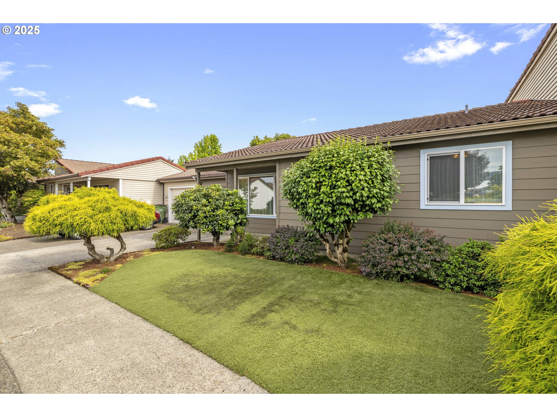 a view of a house with a backyard and a garden