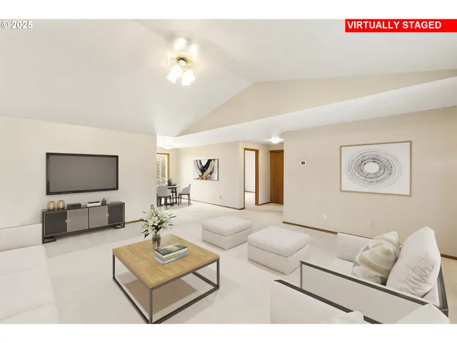 a view of an empty room with a chandelier fan