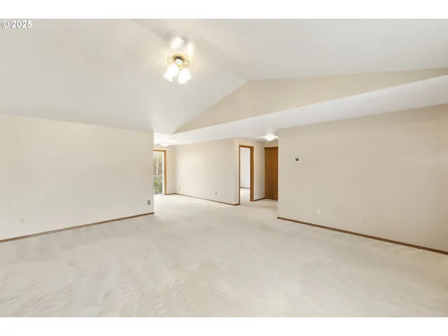 a kitchen with a table chairs refrigerator and cabinets